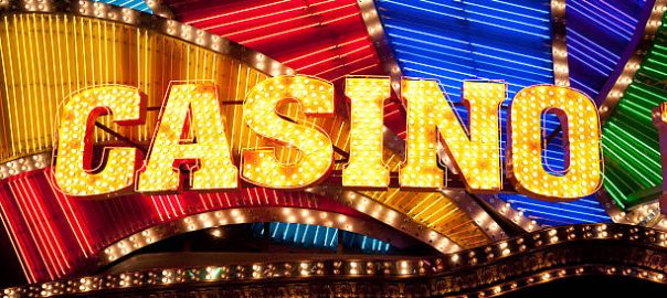 Bright casino sign lit with bulbs and neon lights.