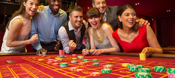 Group Of Friends Playing Roulette In Casino