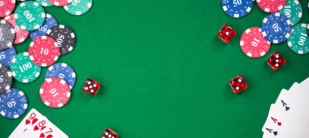 Casino games related items on green table, copy space.