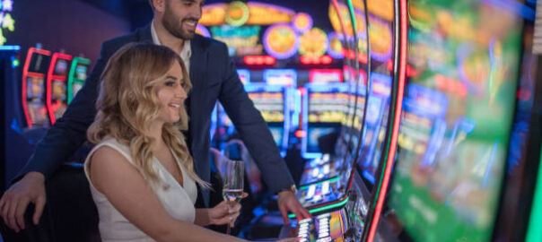 handsome couple having fun and drinking wine at casino